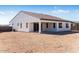 View of house exterior showcasing backyard and tan colored walls at 18104 W Silverwood Dr, Goodyear, AZ 85338