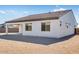 Rear view of house exterior, featuring a covered patio at 18104 W Silverwood Dr, Goodyear, AZ 85338