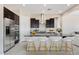 Modern kitchen featuring stainless steel appliances, dark cabinetry, and a spacious island with seating at 18104 W Silverwood Dr, Goodyear, AZ 85338