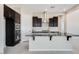 Modern kitchen with dark cabinetry and granite countertops at 18104 W Silverwood Dr, Goodyear, AZ 85338