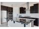 Kitchen island with granite countertop and seating space at 18104 W Silverwood Dr, Goodyear, AZ 85338