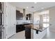 Open-concept kitchen with island, dark cabinetry, and granite countertops at 18104 W Silverwood Dr, Goodyear, AZ 85338