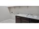 Laundry room with dark cabinets, white countertop and sink at 18104 W Silverwood Dr, Goodyear, AZ 85338