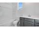 Modern bathroom with gray vanity, bathtub, and shower at 18111 W Hiddenview Dr, Goodyear, AZ 85338