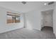 Well-lit bedroom featuring carpet flooring and access to hallway at 18111 W Hiddenview Dr, Goodyear, AZ 85338