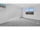 Well-lit bedroom with carpet and large window at 18111 W Hiddenview Dr, Goodyear, AZ 85338