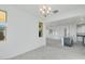 Bright dining room with chandelier and view of kitchen at 18111 W Hiddenview Dr, Goodyear, AZ 85338