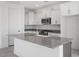 Modern kitchen with white cabinets, granite countertops and island at 18111 W Hiddenview Dr, Goodyear, AZ 85338