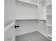 Spacious walk-in closet with ample shelving and rods at 18111 W Hiddenview Dr, Goodyear, AZ 85338