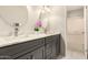 Stylish bathroom featuring double sinks with quartz countertops, modern fixtures, and storage at 1833 W Citrus Way, Phoenix, AZ 85015