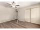 Bedroom view features wood-look flooring, ceiling fan, and closet at 1833 W Citrus Way, Phoenix, AZ 85015