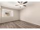 Bedroom features wood-look flooring and large window at 1833 W Citrus Way, Phoenix, AZ 85015