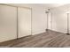 Bedroom includes a closet with sliding doors and wood-look flooring at 1833 W Citrus Way, Phoenix, AZ 85015