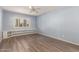 Bedroom with light blue walls, wood floors, and built-in shelves at 1833 W Citrus Way, Phoenix, AZ 85015