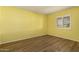 Bedroom with wood-look floors and window with shutters at 1833 W Citrus Way, Phoenix, AZ 85015