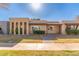 Tan two-story home with arched entryways and landscaped lawn at 1833 W Citrus Way, Phoenix, AZ 85015