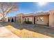 Tan stucco home with arched entryway and paved walkway at 1833 W Citrus Way, Phoenix, AZ 85015