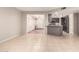 Open-concept living room with neutral tile flooring adjacent to dining area and kitchen at 1833 W Citrus Way, Phoenix, AZ 85015