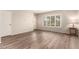 Spacious living room featuring a neutral palette, wood flooring, and bright natural light from a large window at 1833 W Citrus Way, Phoenix, AZ 85015