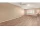 Living room with wood-look floors, ceiling fan, and neutral walls at 1833 W Citrus Way, Phoenix, AZ 85015