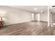 Large living room featuring wood floors, neutral walls, recessed lighting, and ample space for furniture at 1833 W Citrus Way, Phoenix, AZ 85015
