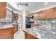 Modern kitchen with dark wood cabinets and granite countertops at 18466 N 5Th Ave, Phoenix, AZ 85023