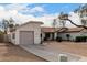 View of the house from the driveway, highlighting the garage at 1913 E Sandra Ter, Phoenix, AZ 85022