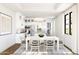 Bright dining room with white table and blue chairs at 20317 W Turney Ave, Buckeye, AZ 85396