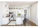 Bright white kitchen with center island and stainless steel appliances at 20317 W Turney Ave, Buckeye, AZ 85396