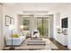 Relaxing living room with a white sofa and access to a patio at 20317 W Turney Ave, Buckeye, AZ 85396