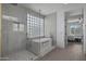 Spa-like bathroom with a freestanding soaking tub and glass shower at 205 W Blue Ridge Way, Chandler, AZ 85248