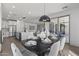 Bright dining room with modern table and chairs, looking into the kitchen at 205 W Blue Ridge Way, Chandler, AZ 85248