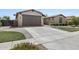 Two-car garage with a paved driveway and landscaping at 205 W Blue Ridge Way, Chandler, AZ 85248