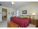 Main bedroom with king bed, ceiling fan, and access to the bathroom at 21705 N Black Bear Lodge Dr, Surprise, AZ 85387