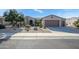 Single-story home with a two-car garage and desert landscaping at 21705 N Black Bear Lodge Dr, Surprise, AZ 85387