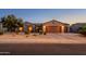 Single-story home with a two-car garage and desert landscaping at 21705 N Black Bear Lodge Dr, Surprise, AZ 85387