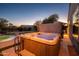 Evening view of a hot tub with a view of the backyard and pool at 21705 N Black Bear Lodge Dr, Surprise, AZ 85387