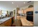 Spacious kitchen with light wood cabinets, granite counters and stainless steel appliances at 21705 N Black Bear Lodge Dr, Surprise, AZ 85387