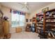 Home office features built-in shelving, a comfy chair, and lots of natural light at 21705 N Black Bear Lodge Dr, Surprise, AZ 85387