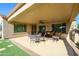 Covered patio with seating area and ceiling fan at 21705 N Black Bear Lodge Dr, Surprise, AZ 85387