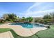 Inviting kidney-shaped pool with waterfall feature at 21705 N Black Bear Lodge Dr, Surprise, AZ 85387