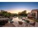 Sunset view of backyard pool and spa at 21705 N Black Bear Lodge Dr, Surprise, AZ 85387