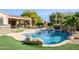 Freeform pool with waterfall feature and artificial turf at 21705 N Black Bear Lodge Dr, Surprise, AZ 85387