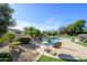 Relaxing pool area with patio furniture and desert landscaping at 21705 N Black Bear Lodge Dr, Surprise, AZ 85387