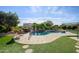 Kidney shaped pool with a waterfall feature and artificial turf at 21705 N Black Bear Lodge Dr, Surprise, AZ 85387