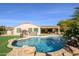 Relaxing pool area featuring a kidney-shaped pool and grassy area at 21705 N Black Bear Lodge Dr, Surprise, AZ 85387