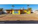 House exterior showcasing a yellow painted home and a gravel yard at 2235 W Villa Rita Dr, Phoenix, AZ 85023