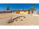 Desert landscaped backyard with yellow home and blue trim at 2235 W Villa Rita Dr, Phoenix, AZ 85023