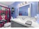 Brightly lit bathroom featuring modern fixtures, gray vanity, and a colorful shower curtain at 2235 W Villa Rita Dr, Phoenix, AZ 85023