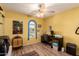 Home office bedroom with arched window, desk, and laminate wood flooring at 2235 W Villa Rita Dr, Phoenix, AZ 85023